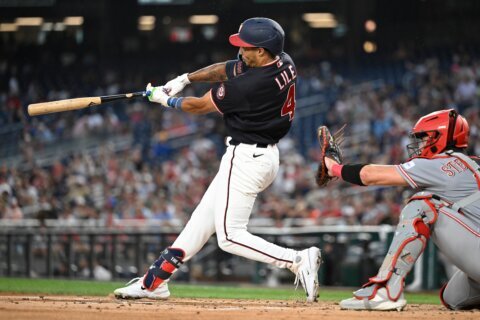 Lile and Ford homer to give the Nationals all their runs in a 5-3 victory over the Reds