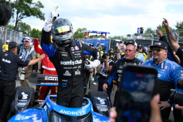 Kyle Kirkwood stands up from his car and celebrates after winning the IndyCar Freedom 250 Grand Prix auto race in Washington, Sunday, Aug. 23, 2026. (AP Photo/Nick Wass)