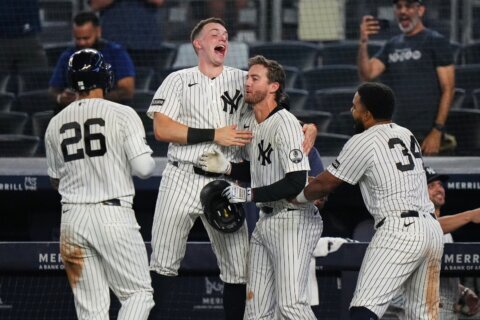 Yankees rally with 2 outs in 9th inning and beat Braves 3-2 in 10 after long rain delay
