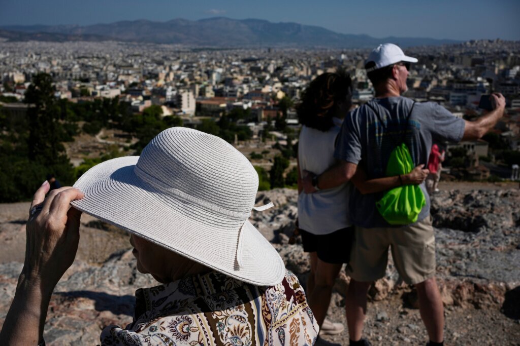 The sunhat is everywhere in Athens as crowds grow larger at ancient Greek sites