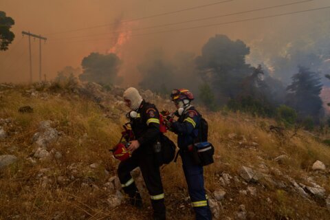 Firefighters scramble to contain fires outside Athens before winds and high temperatures return