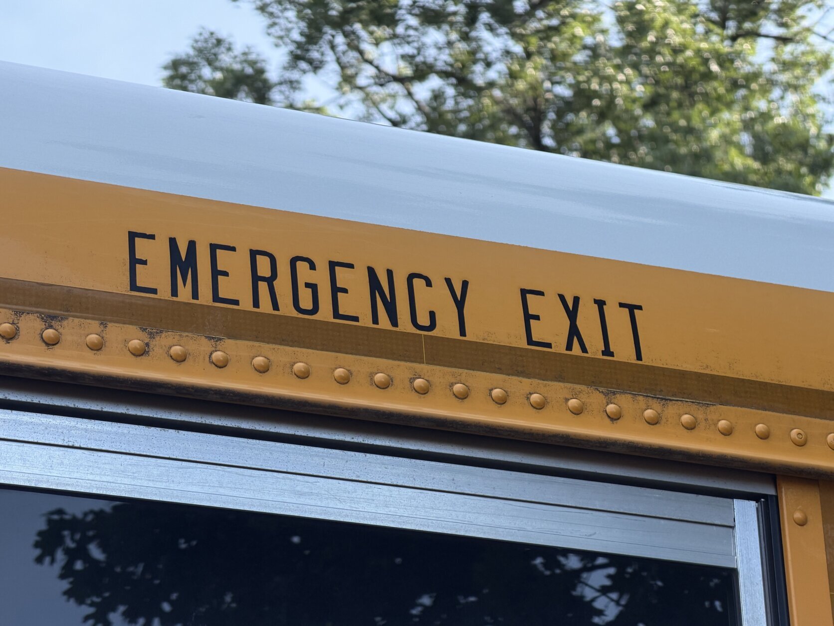 the words emergency exit seen up close on a school bus
