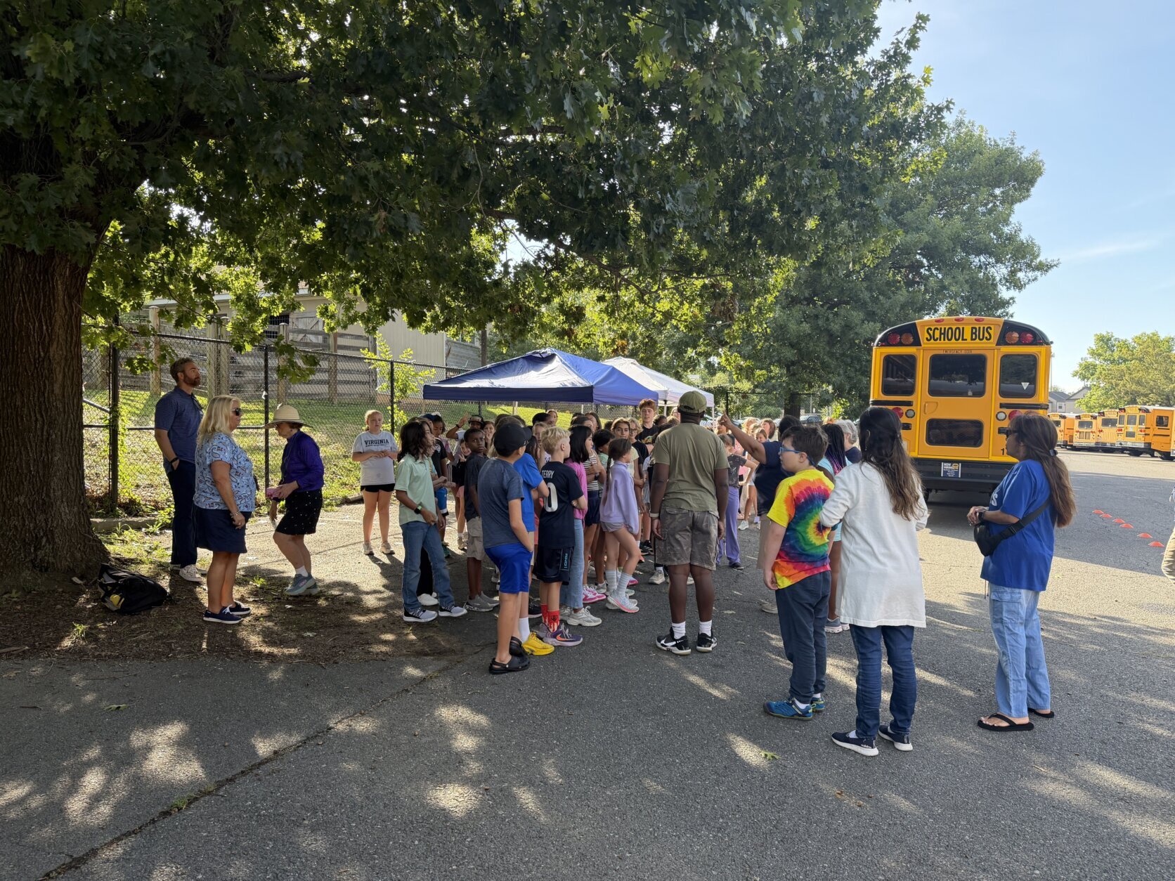 students gathered by a school bus