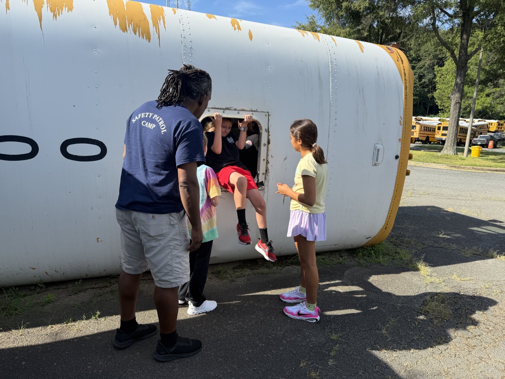 student exits from emergency exit on school bus