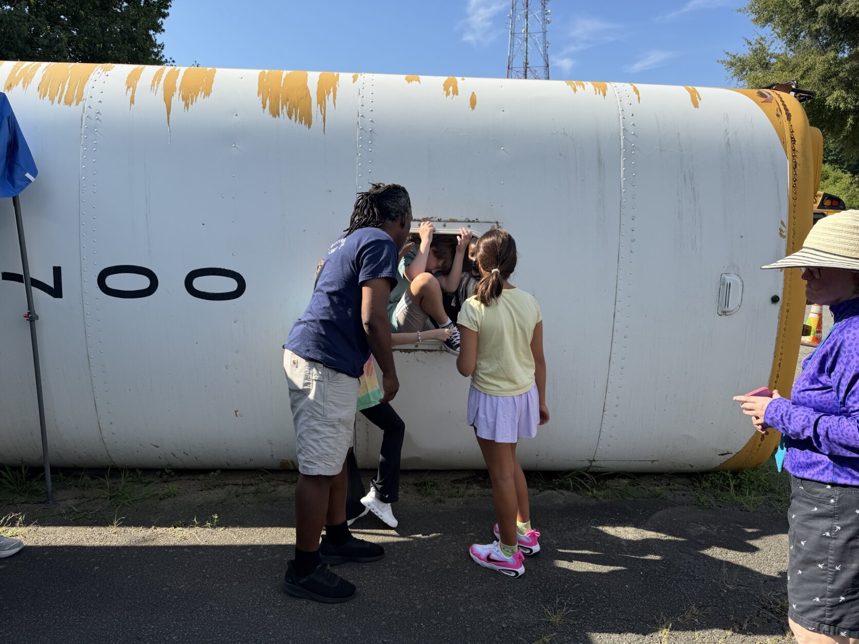 student exits from emergency exit on school bus