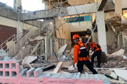 Rescuers dig through rubble and landslides after Indonesia quake kills 47
