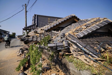 Prime minister visits quake-hit southern Japan as cleanup begins in intense heat