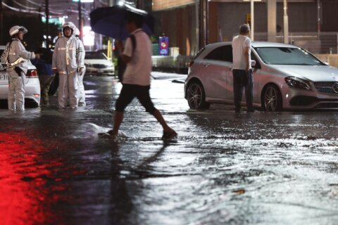 Heavy rain causes flooding near Tokyo that kills 4 and strands travelers