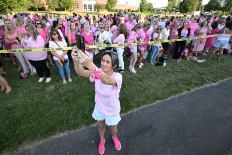 Women in pink rally in support of Lindsay Clancy who is on trial for killing 3 children