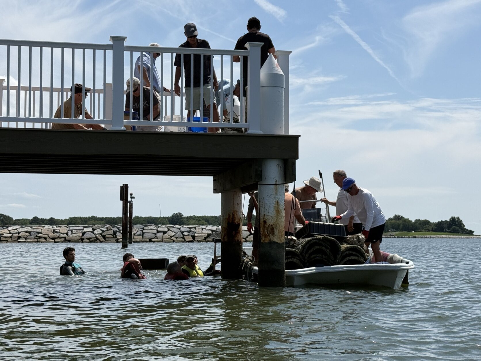 Guys helping to bring oysters to shore