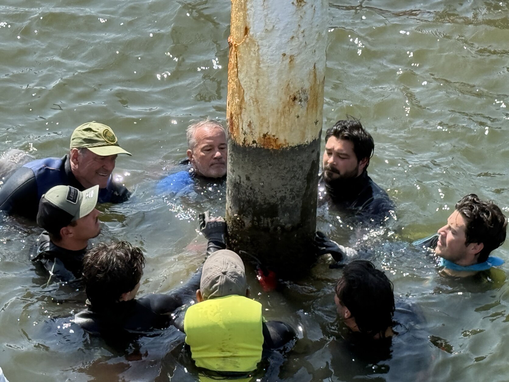 Guys in wetsuits in the water