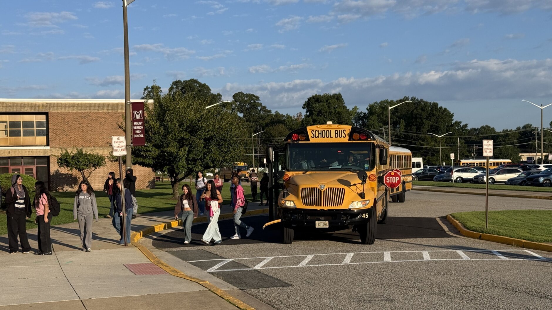 kids get off bus and walk into school