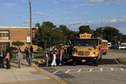 kids get off bus and walk into school