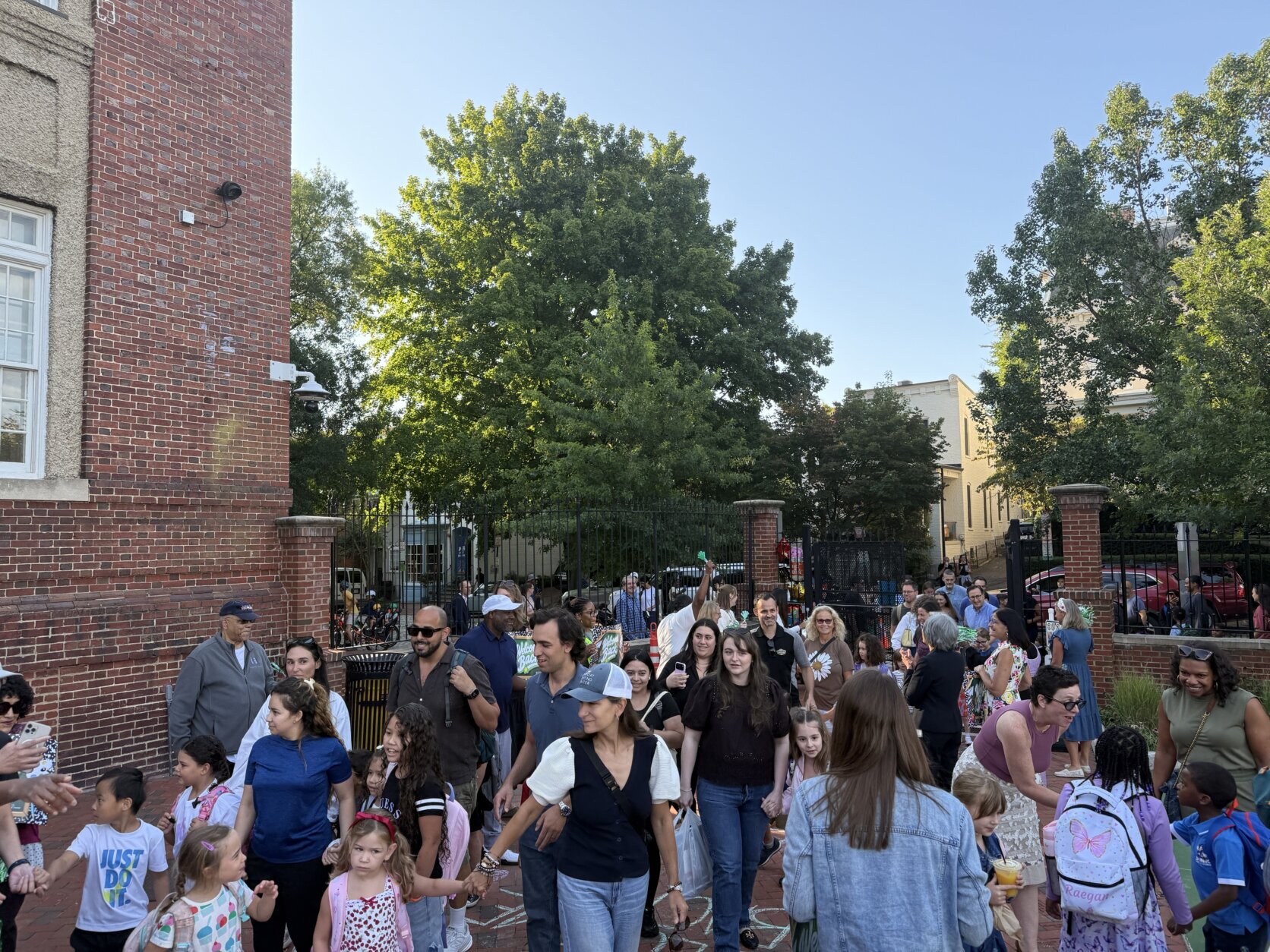 crowd of kids and parents outside in courtyard area