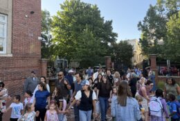 crowd of kids and parents outside in courtyard area