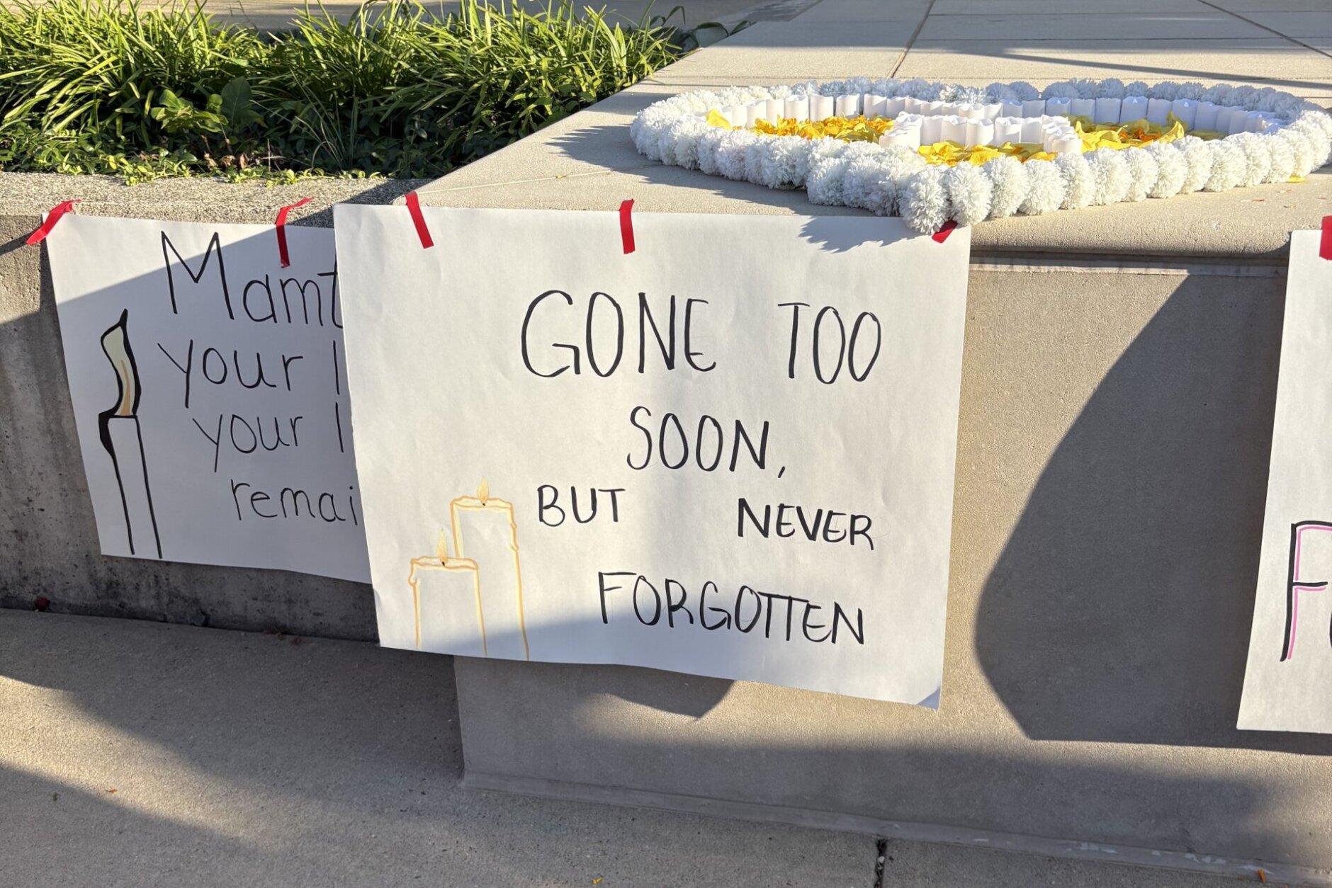"Gone too soon, but never forgotten" sign