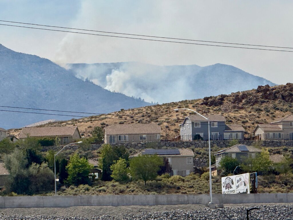 Firefighters are trying to stop a fast-moving Nevada wildfire from spreading to homes in Reno