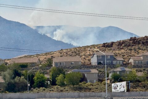 Firefighters are trying to stop a fast-moving Nevada wildfire from spreading to homes in Reno