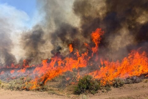 A helicopter battling a Utah wildfire crashes with no word on the 2 people aboard