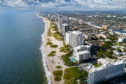 a view from overhead of a resort coastal urban environment by the beach
