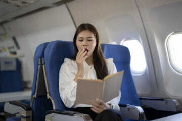 woman yawns on airplane